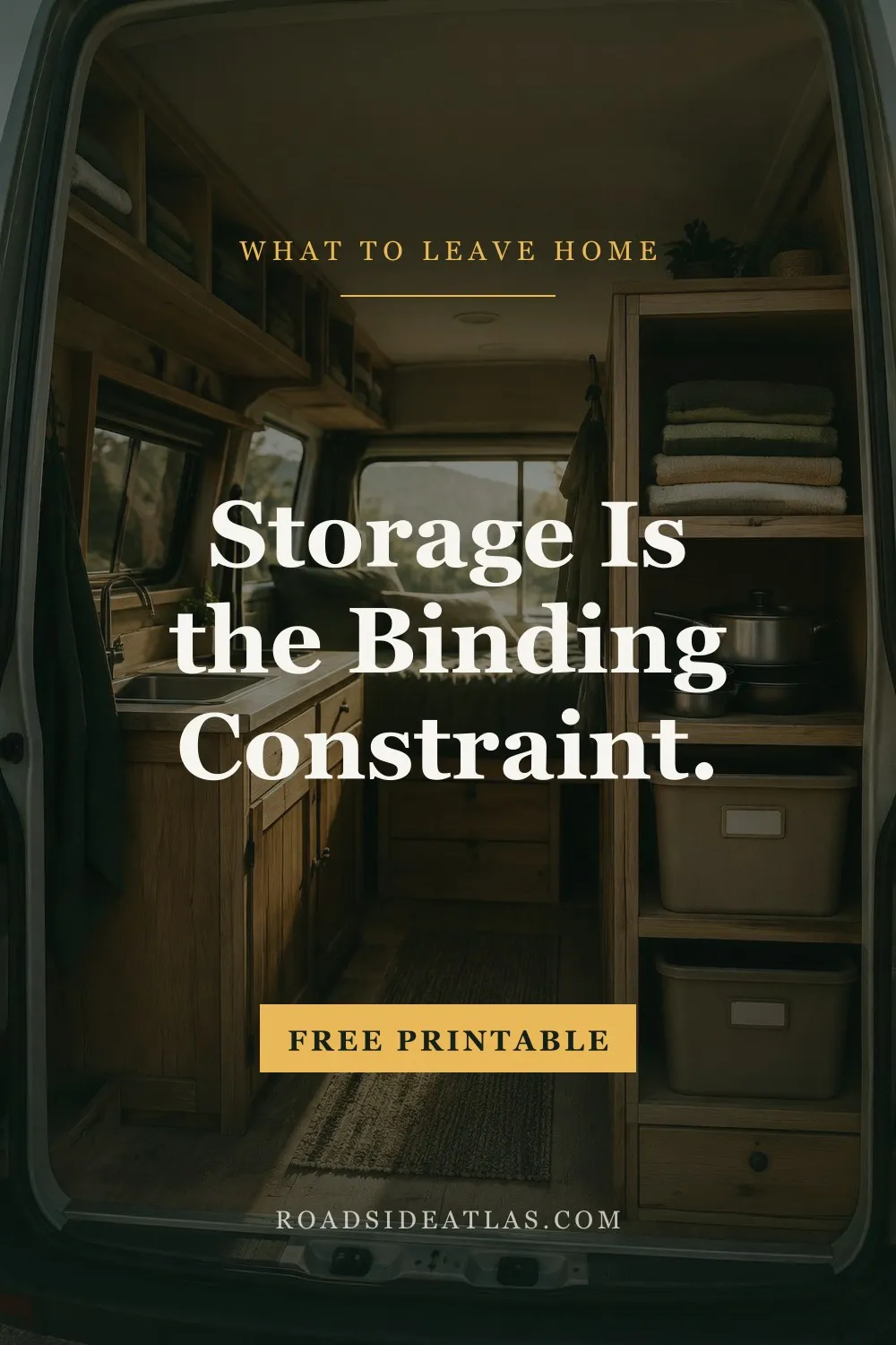 The interior of a camper van seen through the open rear doors, with wooden shelving and labelled storage bins