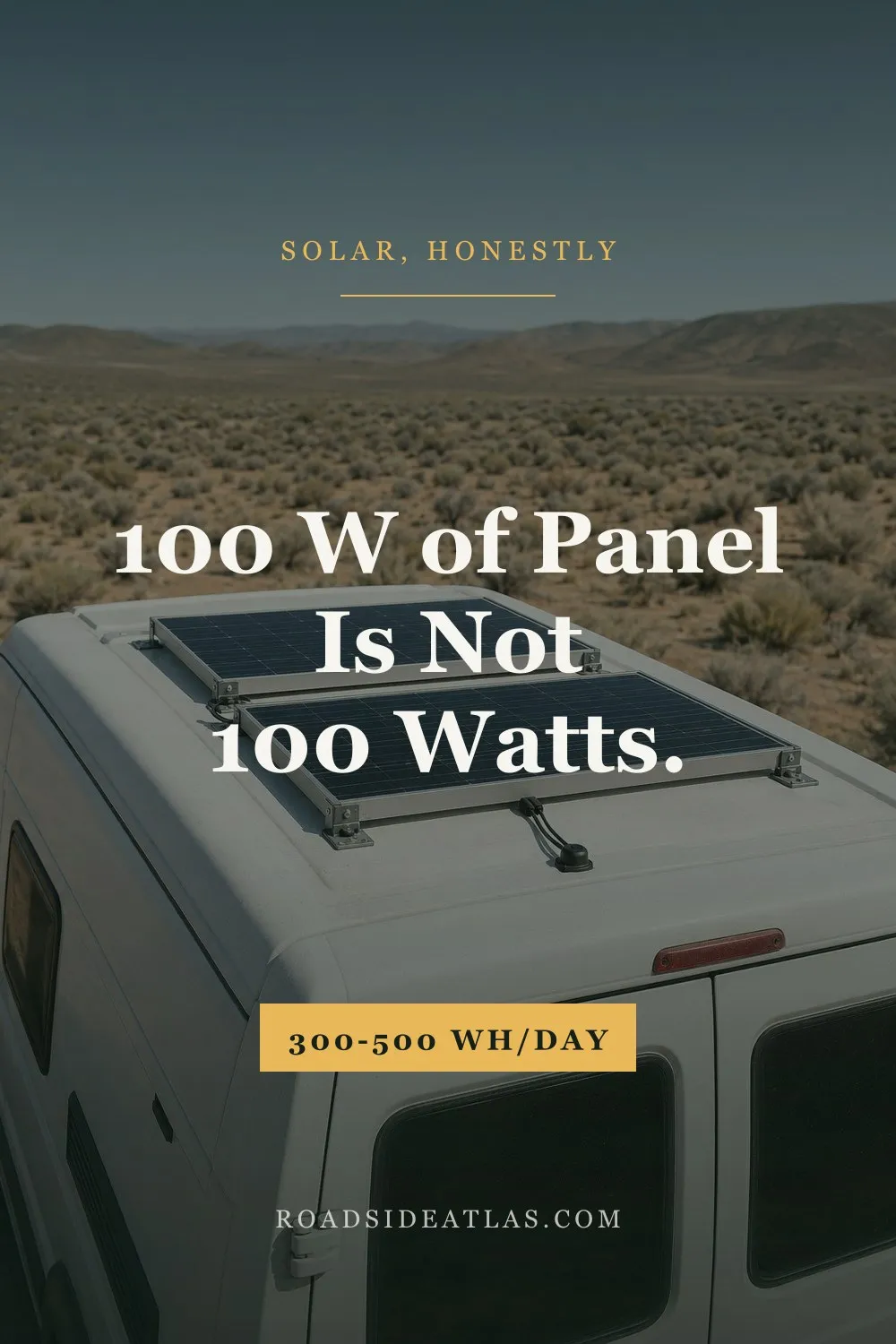 Two solar panels mounted flat on the white roof of a camper van parked in open high-desert scrub